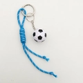 Detailed macro view of woven blue and white nylon cord with soccer ball keychain pendant - Lake Blue Rope + Football