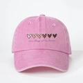 Close-up of pink washed cotton baseball cap with heart prints and one day at a time text - Adjustable / Pink