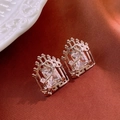 Macro detail of silver tone square zircon earrings with swan design on luxury fabric - Window Thorn Square Stud (HE21918) / Silver (Silver Earring Post)
