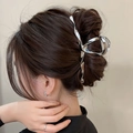 Silver Y2K metal shark hair claw clip holding a full bun on a woman's hair - Silver Irregular Streamline (FJ1343)