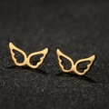 Golden hollow angel wing stud earrings in stainless steel on a dark textured surface - 672 Gold (Angel Wings)