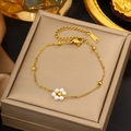 Detailed view of a gold floral bracelet with white pearls on a velvet jewelry box - Gold Single Pearl Flower Bracelet (LM714)