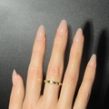 Gold wavy band ring with round clear crystals on index finger with pink manicured nails - Jelly Glue Type / Nude Pink (LHSD-14)