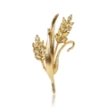 Dettaglio ravvicinato di una spilla a forma di spiga dorata con cristalli gialli e riflessi - Oro