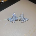 Macro detail of butterfly stud earrings with sparkling cubic zirconia on a beige stand - Silver Butterfly Zircon Pave Stud Earrings