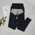 Detailed view of high-waist yoga leggings with black and grey color-block stitching - Black