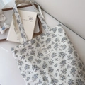 Detailed close-up of floral print cotton tote bag with vintage fabric label branding - Purple Floral Green Leaf Pattern on Beige