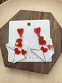 Detailed view of acrylic red heart and white envelope earrings on a wood tray - Love Heart Envelope