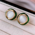 Detailed close-up of vintage gold earrings with green enamel and white cat eye stones - Green-White (Gold Silver Needle)
