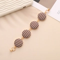 Close-up of heart-shaped zinc alloy bracelet with houndstooth patterned round charms - K722 Round Khaki Houndstooth