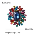 Vintage alloy brooch with dark blue oval crystal and multi-color rhinestones in floral design - Rainbow