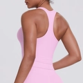 Detail of pink racerback sports tank top showing high-elastic fabric and back muscle lines - Sakura Pink