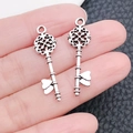 Antique silver 3D key pendant held by hand showing vintage metal texture and size - Vintage Hollow Key (6804)