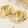 Close-up of polished 14K gold plated C-shape hoop earrings with a mirror finish - C-Shaped Ear Clip 14K Gold