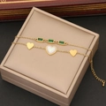 Double layer gold necklace with green rectangular gems and a white heart pendant - Bracelet / Gold