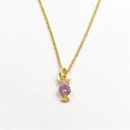 Detailed macro shot of an owl pendant with large pink zircon and gold-plated chain - With Necklace / Pink