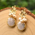 Handmade gold flower earrings with natural freshwater baroque pearls on a wooden surface - Three Flowers Pearl Earrings