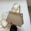 Elegant cream white trapezoid crossbody bag with minimalist golden metallic turn-lock - Off-white