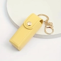 Detail of yellow lychee grain PU leather lipstick holder with gold snap and key ring - Yellow