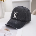 Distressed grey denim baseball cap with white California embroidery in a clean setting - Black