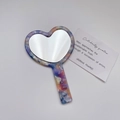 Macro detail of heart-shaped acetate mirror with colorful marble texture on white background - Purple - Heart Tie-dye Pattern
