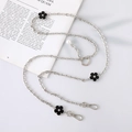 Detail of silver crossbody chain with black flower charms and pearl accent for phones - Silver Chain + Black Flower