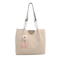 Minimalist beige tote bag with chain handles and a cute pink plush charm on white background - Licorice Green - With Charm