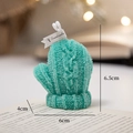 Blue-green knitted mitten scented candle with textured surface on book pages - Dark Green Gloves - Grapefruit Sea