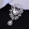 Baroque style silver brooch pendant with oval crystal and pear drop on black backdrop - Silver Base White Gem