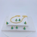 Golden snake chain bracelet with green enamel Christmas charms on white rock pedestal - Emerald Green/Gold