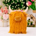Highland Cow plush toy with orange fur and floral crown variant on white surface - Yellow