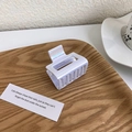 Iridescent rectangular hair claw clip detail on a natural wooden tray in a home setting - Style A Square