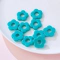 Teal 19mm acrylic flower beads for DIY jewelry making displayed on a white plate - Solid Teal