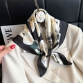 Elegant black and white floral square silk scarf tied on a beige blazer for office wear - 89 Square Scarves / 65