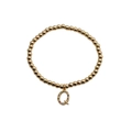 Detailed shot of golden bead bracelet with colorful zircon letter Q pendant - Letter Q