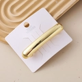 Detail of minimalist gold cylindrical hair clip on a premium greeting card display - Minimalist Cylinder Gold