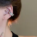 Elegant silver star ear cuff with sparkling cubic zirconia on a female model - Star Shaped Design (24#) / Silver