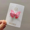 Detail of pink fabric butterfly hair clip with rhinestones on a white display card - Rose Red