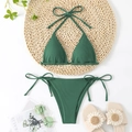 Flat lay of dark green ribbed bikini set with halter top and side-tie bottoms on a straw mat - Army Green