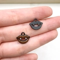 Pair of vampire lip charms in matte black and brown glitter finish for DIY jewelry - Black Vampire Teeth
