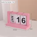 Pink wooden flip calendar with metal rings and white date cards on a desk - Pink MDF Style