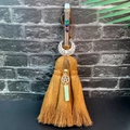 Detail of handmade witch broom with chakra beads, silver moon charm and green crystal - Fluorite + Moon + Aventurine