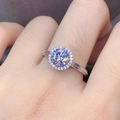Silver halo engagement ring featuring a round moissanite center stone on a female hand - Round Ring Ljz-215 / Adjustable Open