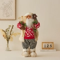 Standing Santa Claus doll in red knitted sweater holding wooden skis and lodge backpack - Red Sweater / 60CM