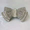 Elegant silver bow-shaped clutch bag covered in sparkling crystals for evening parties - Silver