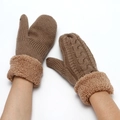 Detail of camel knitted gloves featuring cable patterns and thick plush cuffs - Camel