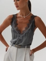 Close-up of silk dark grey V-neck tank top with delicate lace edges and satin texture - Gray