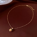 Close-up of 18K gold plated necklace with colorful opal stones on dark red silk - Necklace - Gold