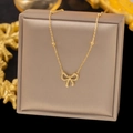 Elegant 18K gold bow necklace for women featuring fine chain with delicate bead accents - Beaded Bow Tie Necklace Gold