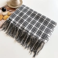Detailed shot of black and white plaid cashmere scarf with fringes next to coffee cup - 200x66cm / Black White and Blue Striped